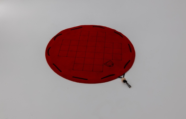 Fox and geese board game on a round red leather playing field